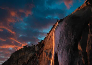Cold days in the middle of Winter doesn’t always draw a lot of people to Yosemite Valley. The one exception is a short lived phenomenon in which the shadow of El Capitan sweeps across the face of the cliffs to align perfectly with Horsetail Fall causing the waterfall to glow in the dazzling colors of the setting sun. The effect gives the impression of falling lava or fire reminiscent of Yosemite’s famous Firefall where hot glowing embers were pushed off the cliffs of Glacier Point creating literally falling fire that could be seen from the valley floor. The Firefall event was discontinued in 1968 by the National Park Service in part due to huge crowds it drew and that it was not a naturally occurring event. But sometimes nature is more clever than we think and had been having its own version of Firefall each February for thousands of years but it wasn’t really noticed until 1973 when photographer Galen Rowell snapped his now famous photograph of Horsetail Fall glowing in the evening sun. Since that time each February photographers and nature lovers have been flocking to Yosemite to witness the natural version. The event has become so popular that the National Park Service now sections of areas to accommodate special parking. As is often the case with nature, the show varies from day to day and year to year and even minute to minute. Weather can make or break the event and as often is the case it may not occur at all. Clouds cause many to give up early and head down the long road for home only to have the sun pop out at the last minute creating fantastic light that lasts just a few minutes and then is gone. Drought in California made this year very questionable but a bit of snow and a last minute rainstorm caused the fall to spring to life. If you arrive early Horsetail Fall may be barely flowing but as the sun warms the High Sierra, the snow melts and the waterfall's flow picks up. So be sure to stick it out to the last minute. Thi