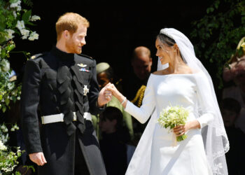 Britain's Prince Harry, Duke of Sussex and his wife Meghan, Duchess of Sussex emerge from the West Door of St George's Chapel, Windsor Castle, in Windsor, on May 19, 2018 after their wedding ceremony. / AFP PHOTO / POOL / Ben BirchallBEN BIRCHALL/AFP/Getty Images
