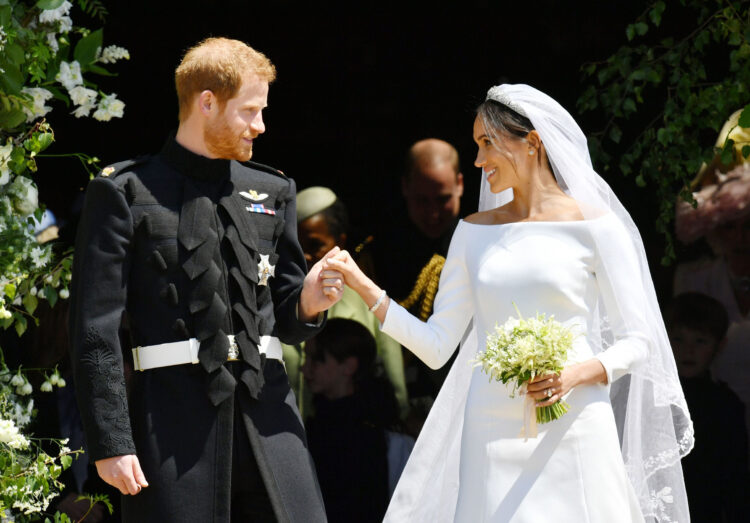 Britain's Prince Harry, Duke of Sussex and his wife Meghan, Duchess of Sussex emerge from the West Door of St George's Chapel, Windsor Castle, in Windsor, on May 19, 2018 after their wedding ceremony. / AFP PHOTO / POOL / Ben BirchallBEN BIRCHALL/AFP/Getty Images