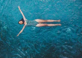 Overhead View Of The Young Woman Floating In The Pool20s, Asia, Asian, Beautiful, Blue, Copy space, Enjoy, Floating, Gorgeous, Holiday, Leisure, Lifestyle, Natural, Outdoor, People, Pool, Recreation, Relaxing, Sensual, Stocksywac, Stunning, Summer, Summertime, Sunbathe, Swimming, Swimming pool, Swimsuit, Swimwear, Tanned, Thailand, Tropic, Turquoise, Vacation, Vertical, Water, Water, Wet, Woman, Young