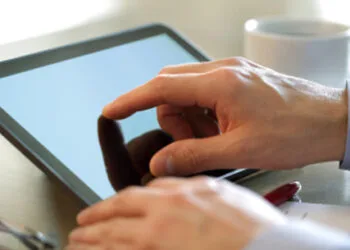Businessman finger pointing to the screen of a tablet-pc